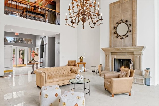 living room with a towering ceiling, a fireplace, and french doors