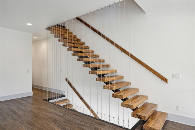 stairs featuring baseboards, wood finished floors, and recessed lighting