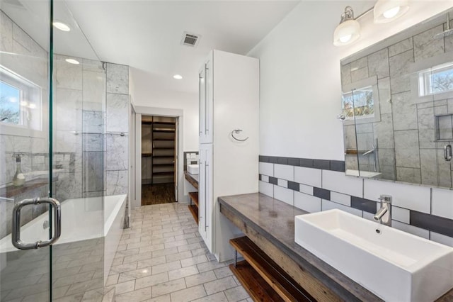 full bath with vanity, recessed lighting, a stall shower, a bathtub, and visible vents