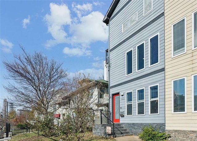 view of property exterior with fence