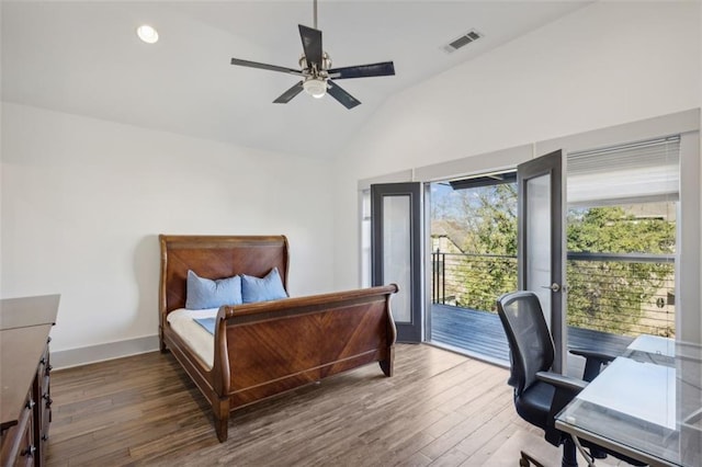 bedroom with wood finished floors, visible vents, baseboards, vaulted ceiling, and access to exterior