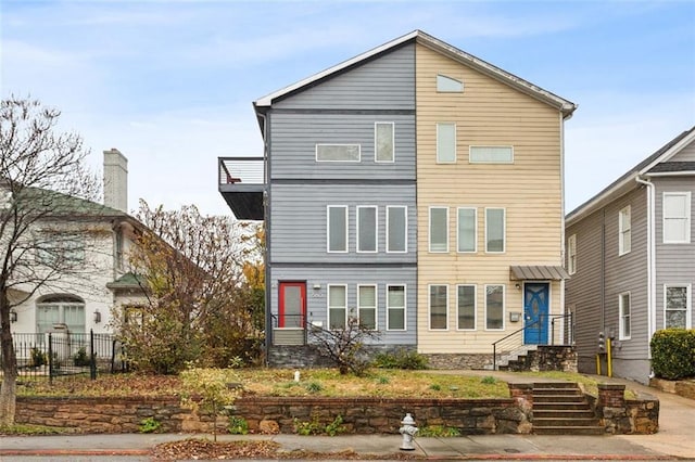 view of front of home with entry steps and fence