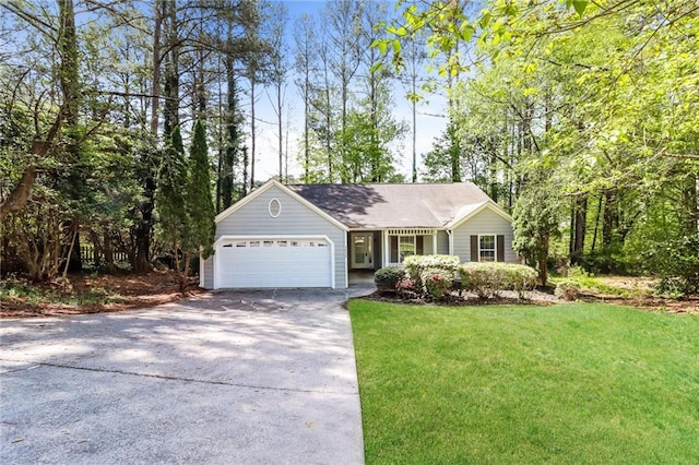 view of front of home featuring an attached garage, a front yard, and concrete driveway