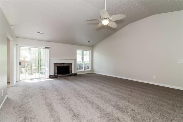 unfurnished living room with lofted ceiling, baseboards, visible vents, and carpet flooring
