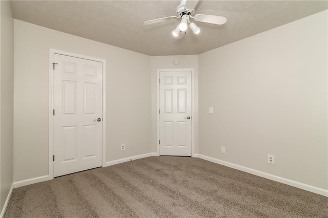 unfurnished bedroom with baseboards, carpet flooring, and a textured ceiling
