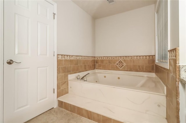 full bathroom with a whirlpool tub, visible vents, and tile patterned floors