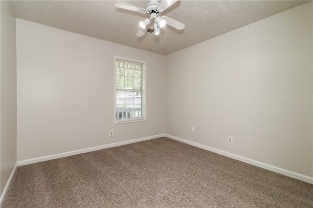 carpeted spare room with baseboards and ceiling fan