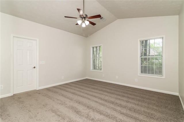 spare room with vaulted ceiling, carpet, visible vents, and a ceiling fan