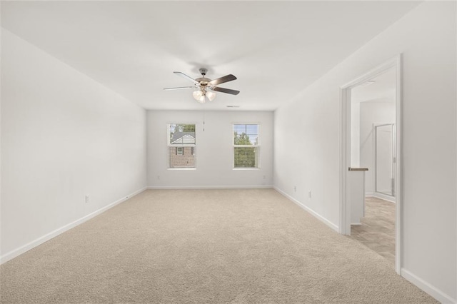 empty room featuring light colored carpet and ceiling fan