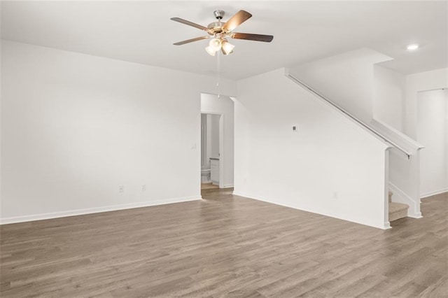 unfurnished living room with hardwood / wood-style floors and ceiling fan