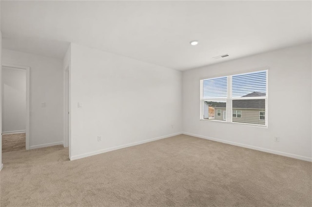 unfurnished room with light colored carpet