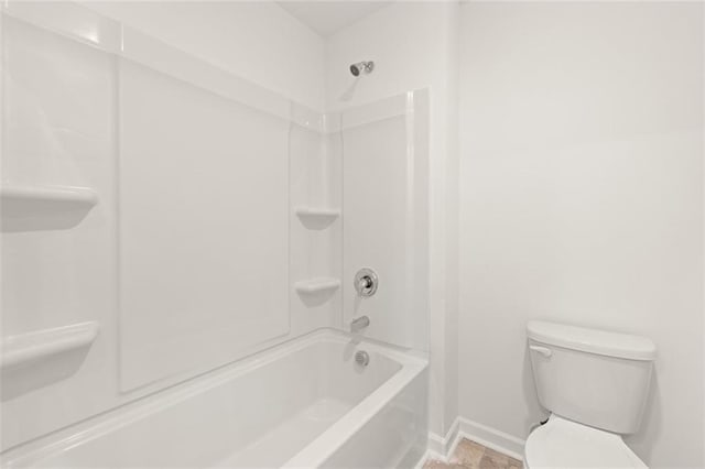 bathroom featuring shower / washtub combination and toilet