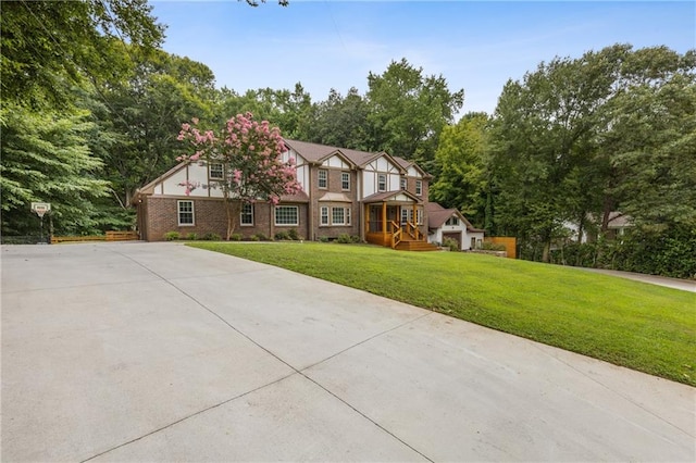 tudor-style house with a front lawn and brick siding