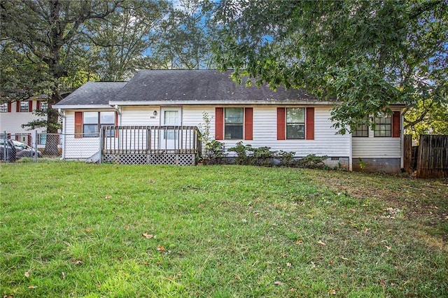 view of front of home with a deck and a front lawn