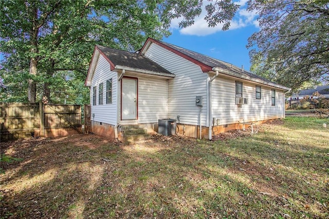 view of property exterior featuring cooling unit, a lawn, and central air condition unit