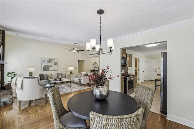 255 Broken Lance Pl, Johns Creek, GA 30022 - dining area with a chandelier, wood finished floors, ornamental molding, ceiling fan, and a textured ceiling