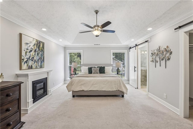 255 Broken Lance Pl, Johns Creek, GA 30022 - bedroom featuring a barn door, baseboards, a tray ceiling, a textured ceiling, and crown molding