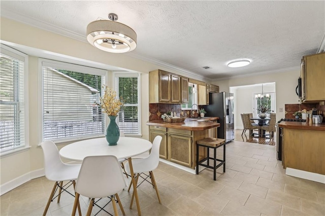 255 Broken Lance Pl, Johns Creek, GA 30022 - dining room with a chandelier, ornamental molding, a textured ceiling, light tile patterned floors, and baseboards