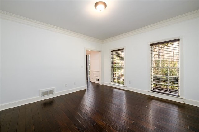 empty room with visible vents, baseboards, ornamental molding, and dark wood-style flooring