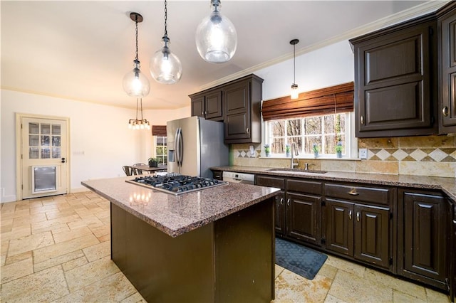 kitchen with decorative backsplash, stainless steel appliances, a sink, stone countertops, and stone tile floors