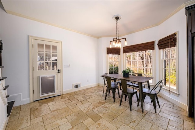 dining room featuring baseboards, a notable chandelier, stone tile floors, and crown molding