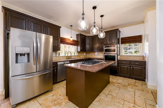 kitchen featuring dark brown cabinetry, stone tile floors, a sink, and stainless steel appliances