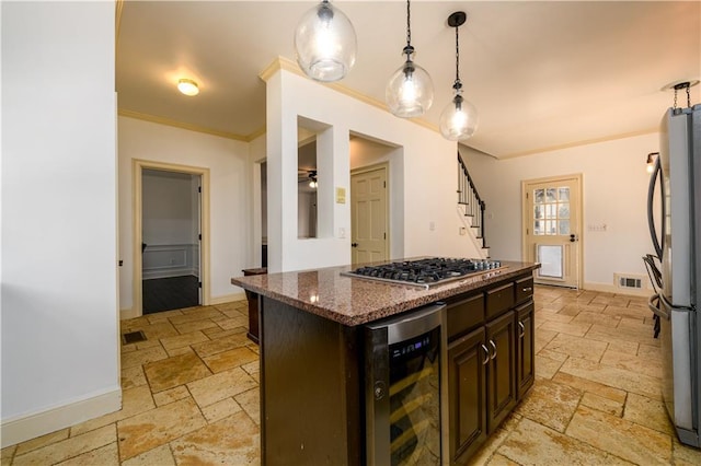 kitchen featuring wine cooler, appliances with stainless steel finishes, stone tile flooring, baseboards, and ornamental molding