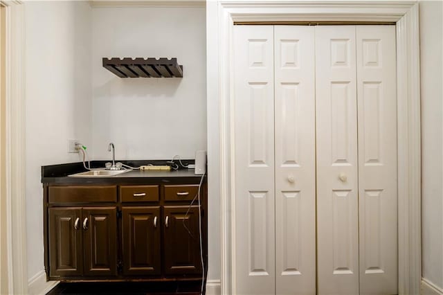 bar featuring indoor wet bar and a sink