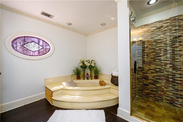 full bathroom with a tile shower, ornamental molding, a garden tub, visible vents, and wood finished floors