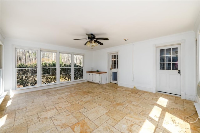 unfurnished sunroom featuring a ceiling fan