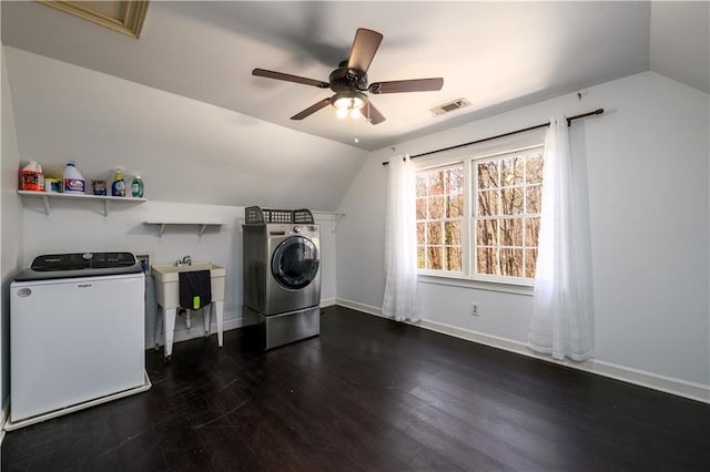 laundry room featuring dark wood-type flooring, baseboards, visible vents, washer and dryer, and laundry area