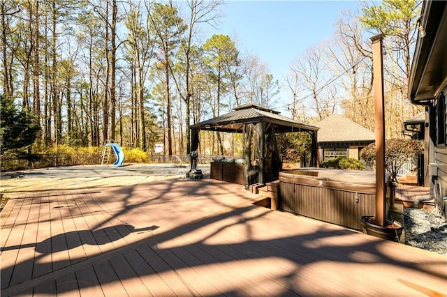 deck featuring a gazebo and a hot tub
