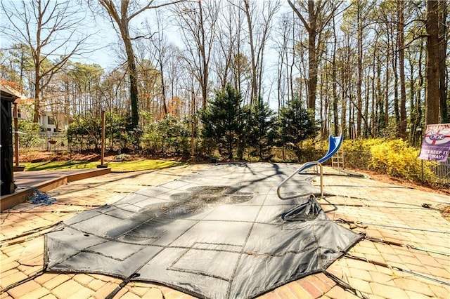 view of swimming pool with fence