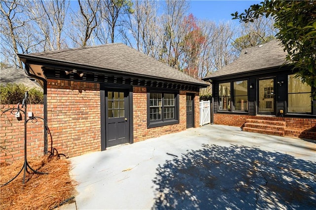 exterior space featuring an outbuilding and fence