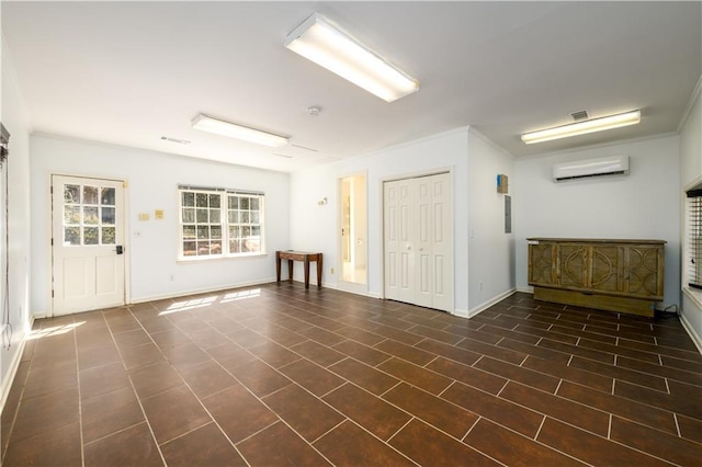 empty room featuring baseboards, a wall mounted air conditioner, and ornamental molding