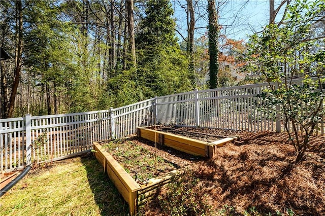 view of yard featuring a vegetable garden and fence