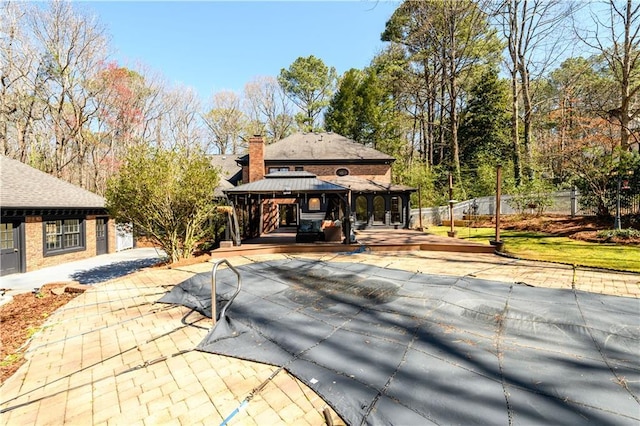 view of swimming pool featuring a gazebo and fence