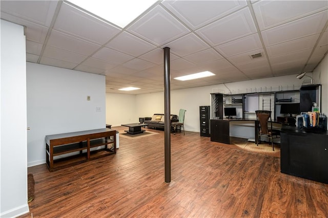 finished basement with wood finished floors, visible vents, and baseboards