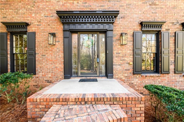 property entrance with brick siding