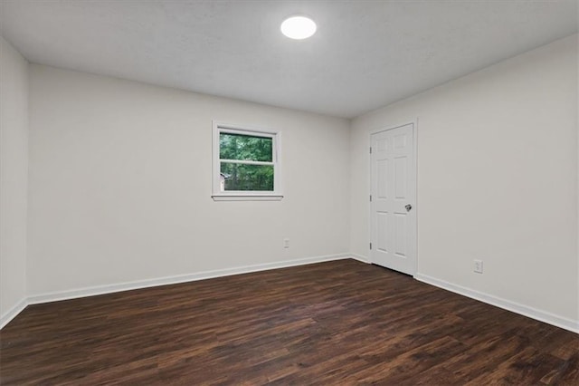 2091 Chestnut Log Dr, Lithia Springs, GA 30122 - empty room with dark wood-style flooring and baseboards
