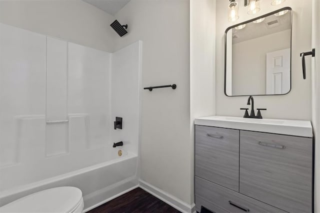 2091 Chestnut Log Dr, Lithia Springs, GA 30122 - full bath with toilet, vanity, wood finished floors, shower / tub combination, and baseboards