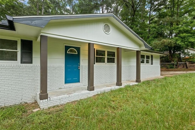 2091 Chestnut Log Dr, Lithia Springs, GA 30122 - view of front of house with brick siding, covered porch, and a front lawn