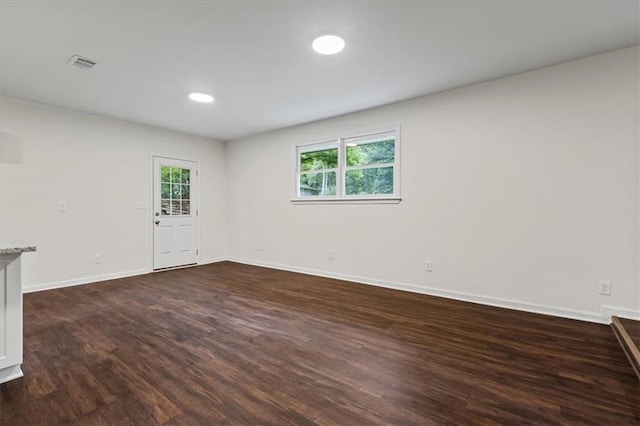2091 Chestnut Log Dr, Lithia Springs, GA 30122 - spare room with dark wood-type flooring, healthy amount of natural light, baseboards, and recessed lighting
