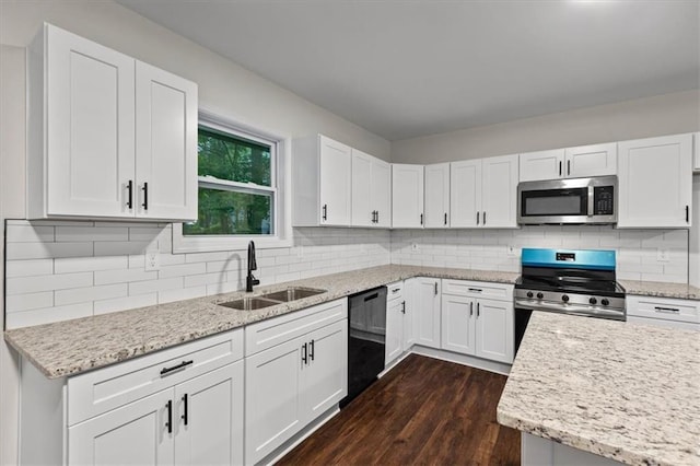 2091 Chestnut Log Dr, Lithia Springs, GA 30122 - kitchen with appliances with stainless steel finishes, a sink, dark wood-style floors, white cabinets, and light stone counters