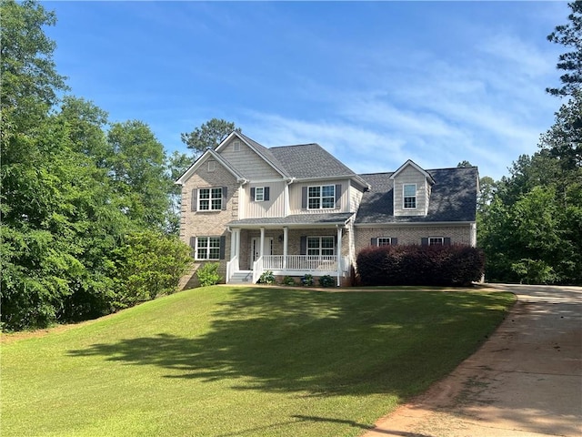 view of front of home featuring a porch and a front lawn