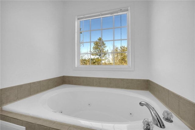 bathroom with a relaxing tiled tub