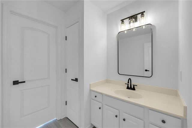 bathroom with hardwood / wood-style flooring and vanity