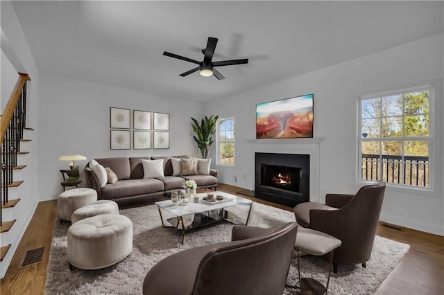 living room with plenty of natural light, ceiling fan, and hardwood / wood-style floors