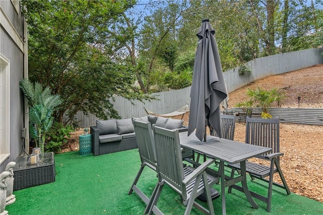view of patio featuring outdoor lounge area, a fenced backyard, and outdoor dining area