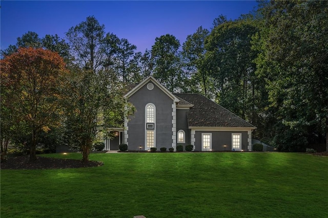 view of front of property featuring a front lawn and stucco siding